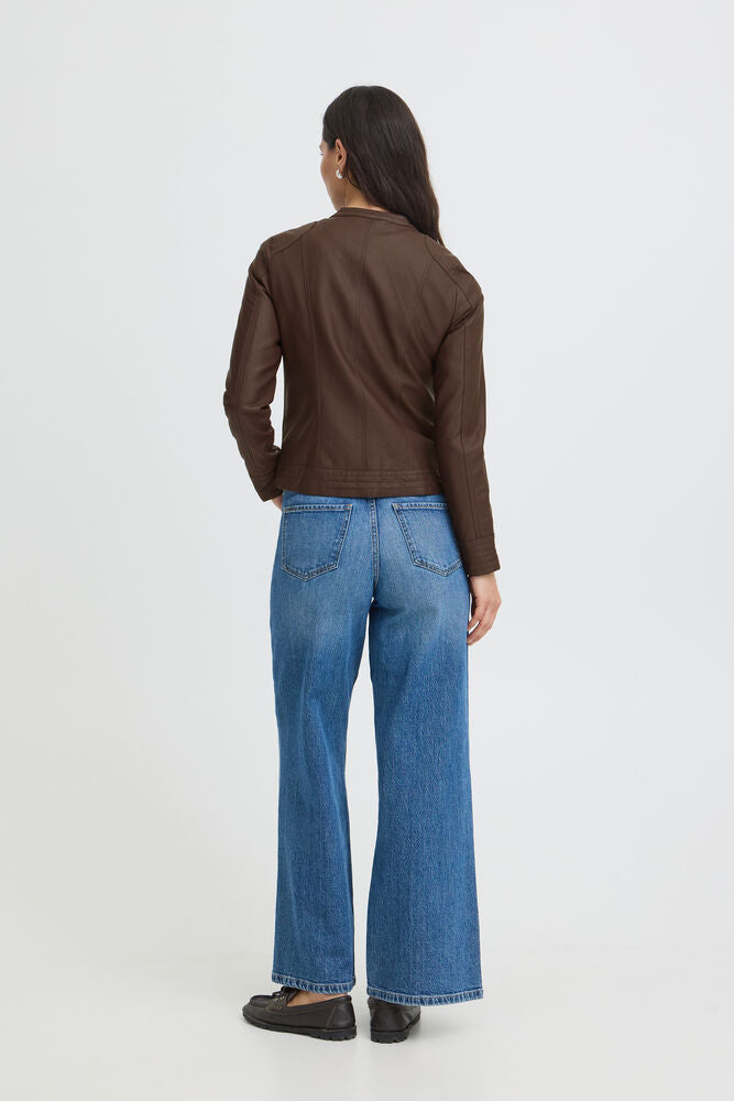 Person wearing a brown jacket and blue jeans on a white background