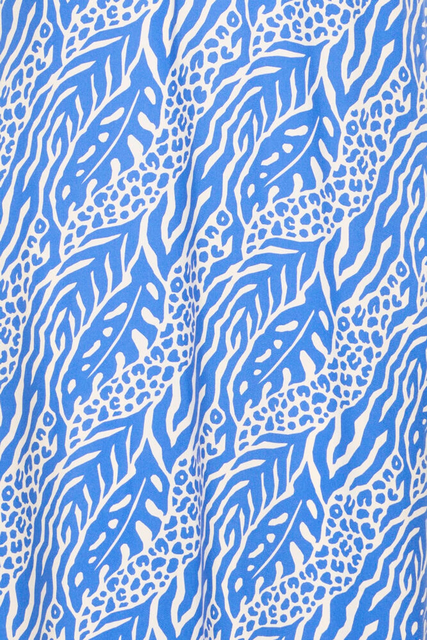 Blue and white animal print pattern on a fabric background