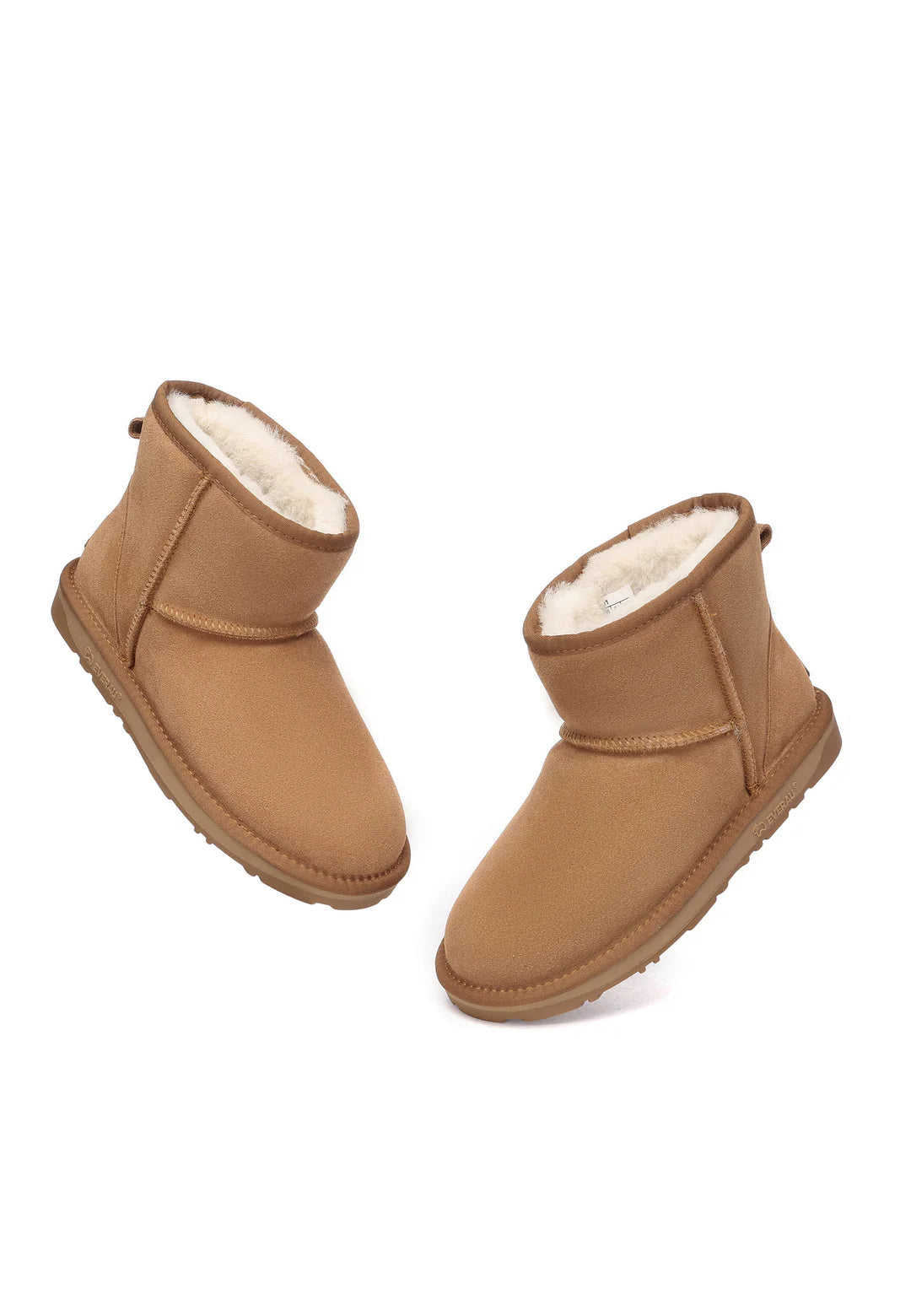 Pair of tan boots with white fur lining on a white background