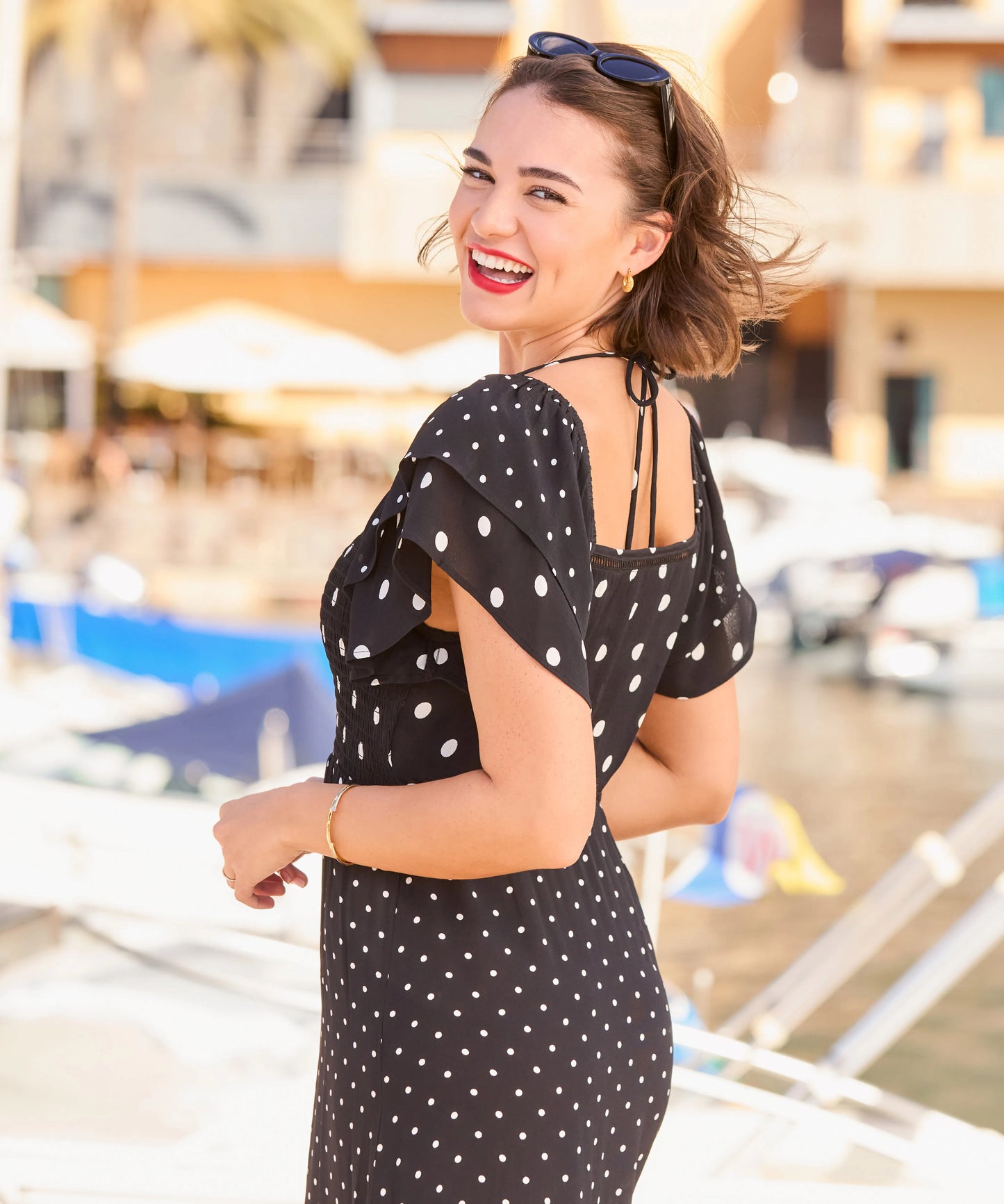 Woman in a black polka dot dress with a blurred background