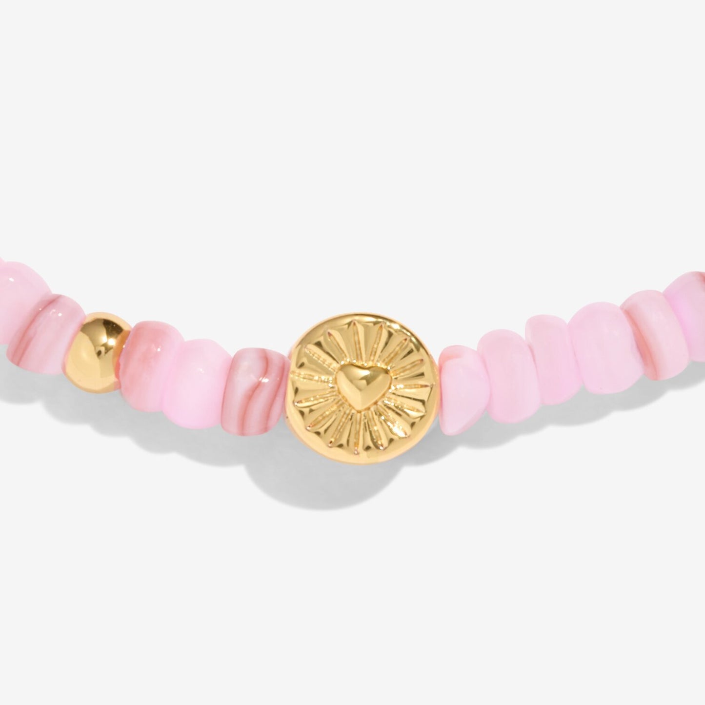 Bracelet with pink beads and gold accents on a white background