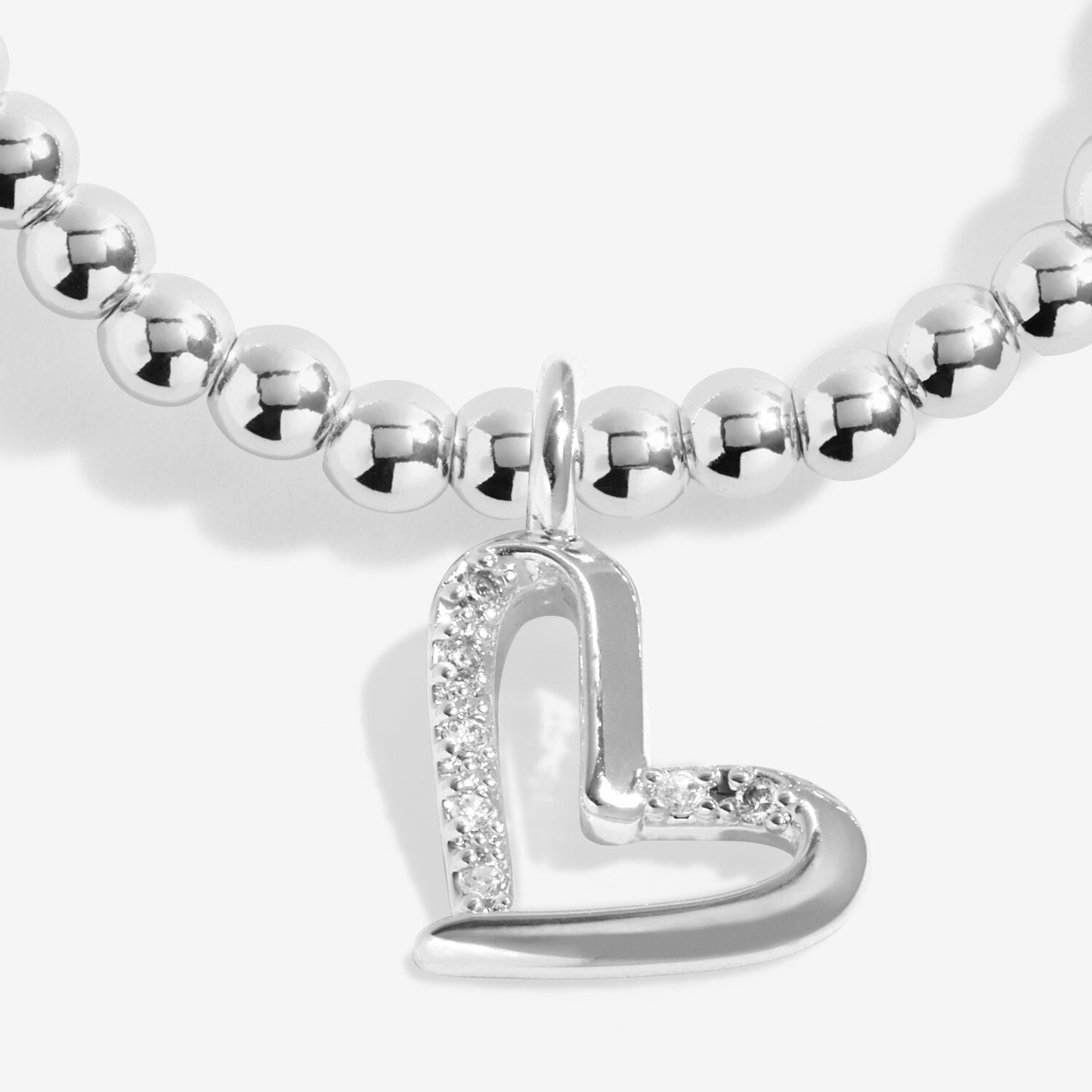 Silver beaded bracelet with a heart-shaped charm on a white background