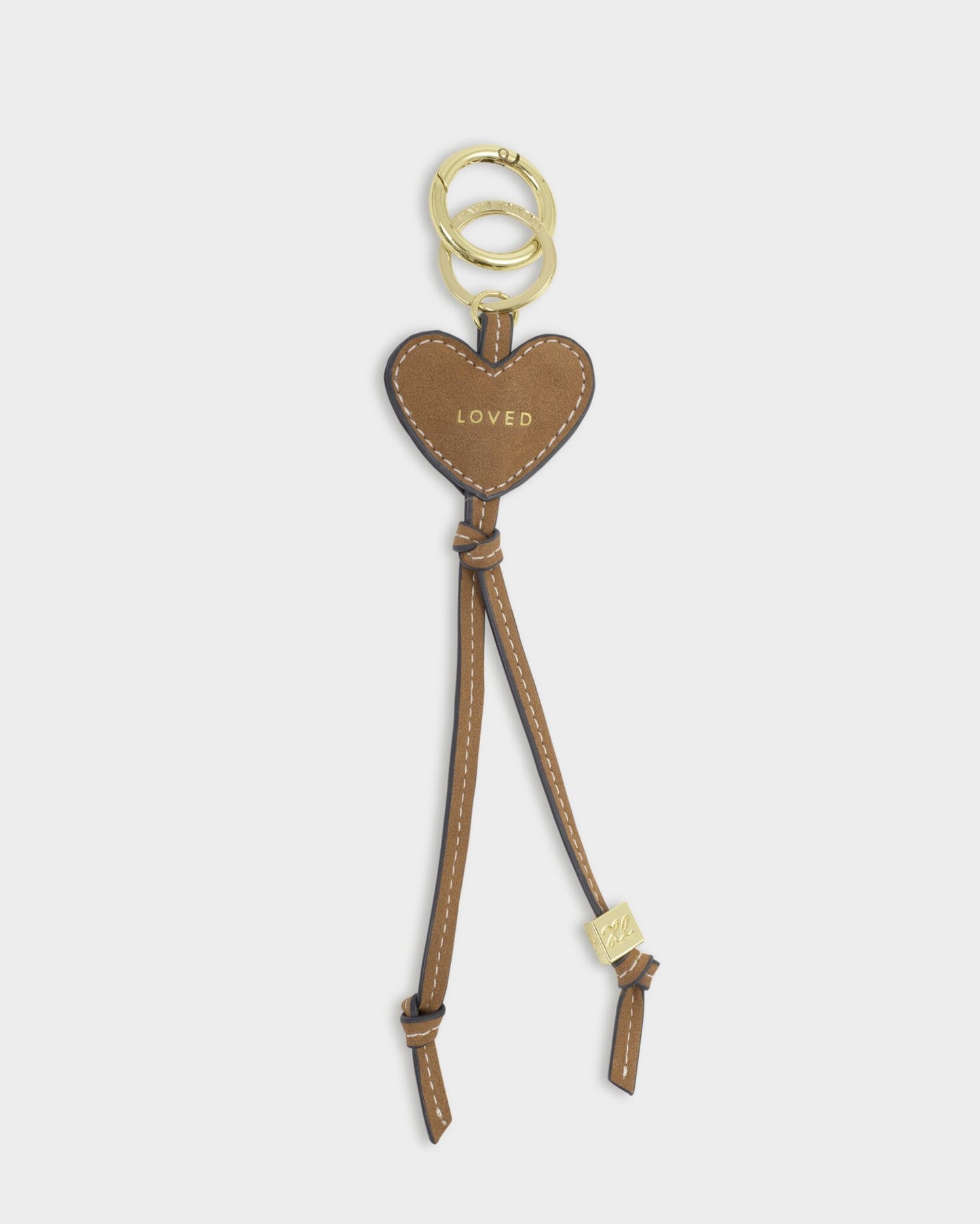 Heart-shaped keychain with 'LOVED' text on a white background