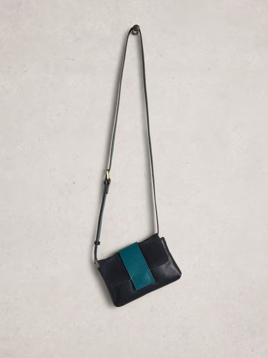 Navy crossbody bag with a blue stripe on a light grey background