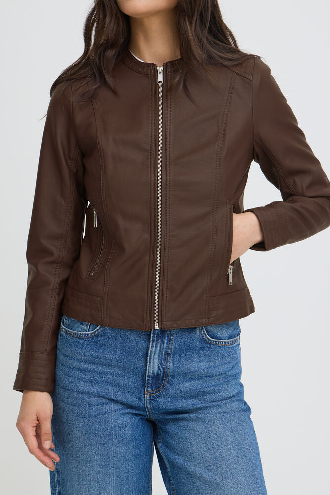 Brown leather jacket worn by a person on a white background
