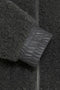 Close-up of a textured dark gray fabric with a zipper