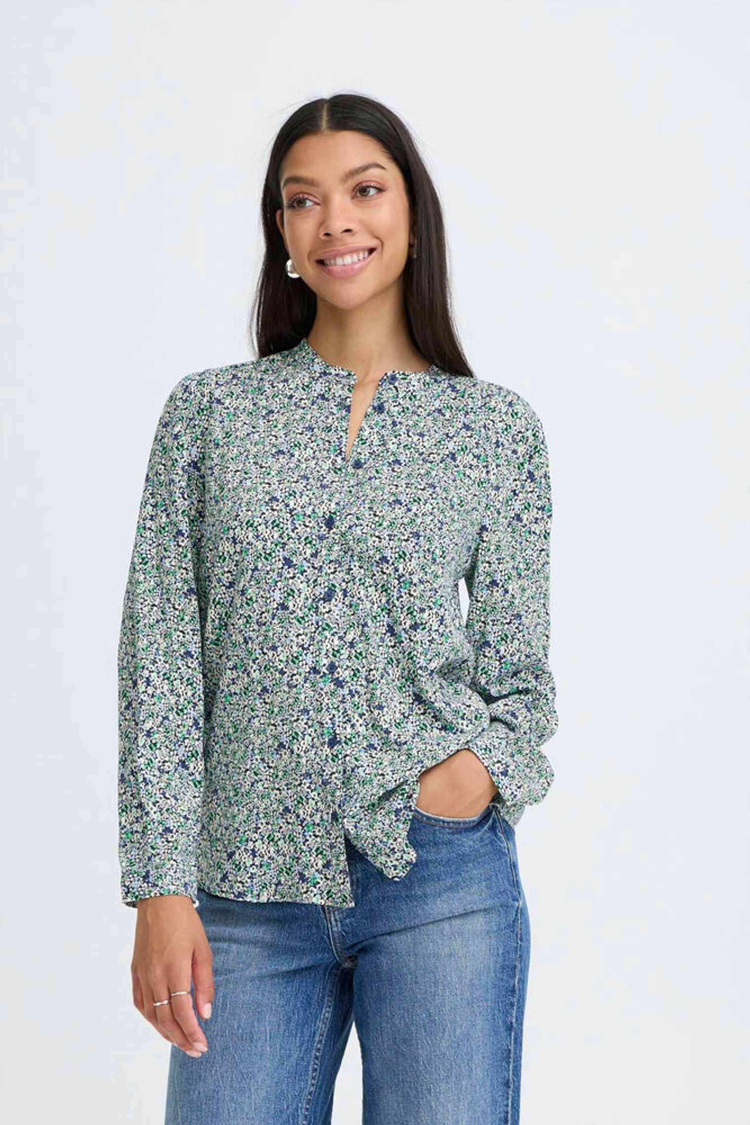 model wearing blue floral shirt and jeans