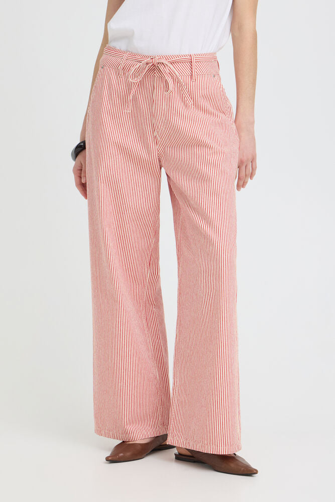 Person wearing red striped pants on a white background