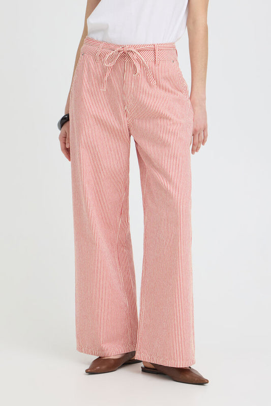 Person wearing red striped pants on a white background
