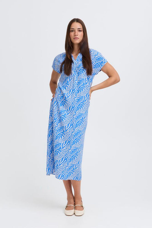 Woman wearing a blue patterned dress on a white background