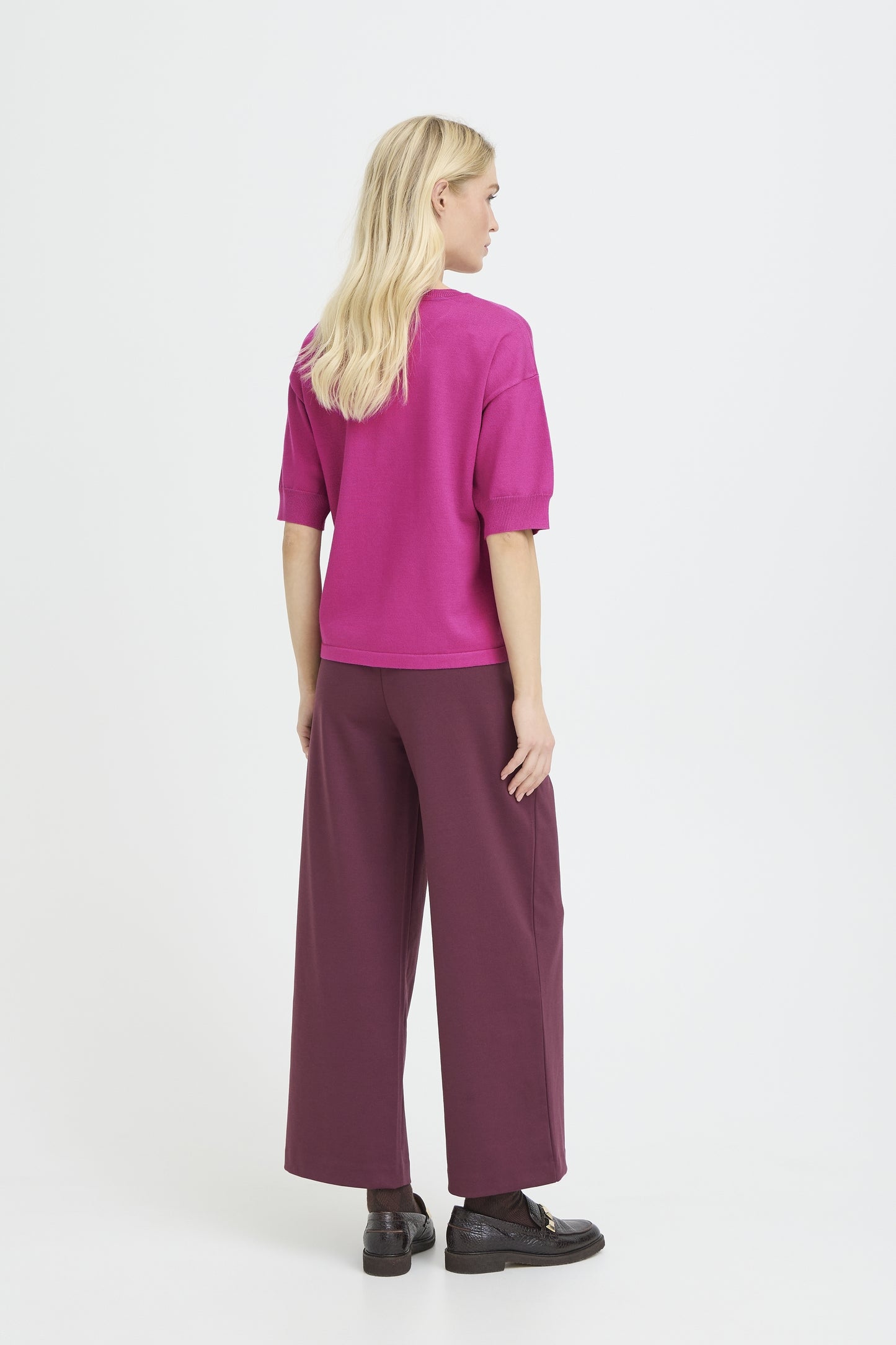 Back view of model wearing a short sleeved pink knit