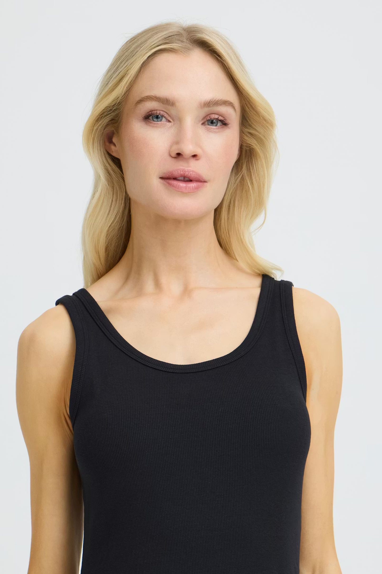 Woman wearing a black dress against a white background
