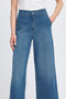 Blue jeans worn by a person on a white background