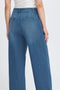 Blue jeans worn by a person on a white background
