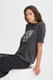 Woman wearing a dark gray t-shirt with a logo on a white background