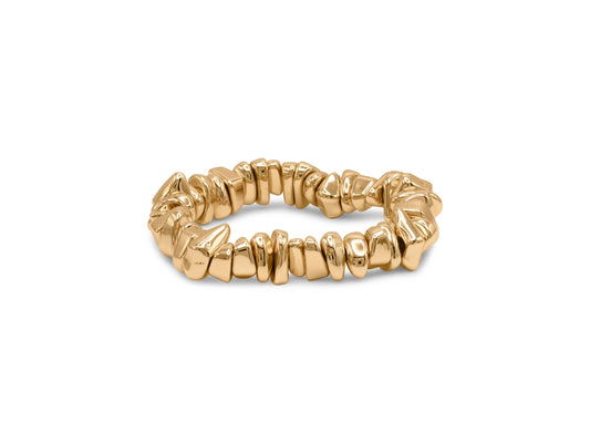 Gold stretch bracelet with textured design on a white background