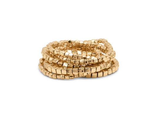 Gold beaded bracelet on a white background