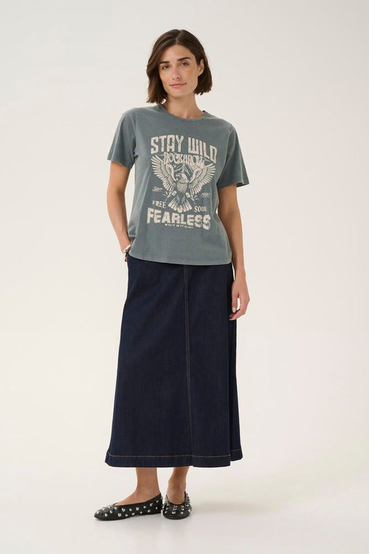 Person wearing a gray t-shirt with text and graphics, paired with a long dark skirt on a white background