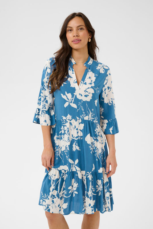 Woman wearing a blue floral dress on a white background