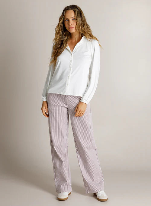 Model wearing white long sleeved shirt