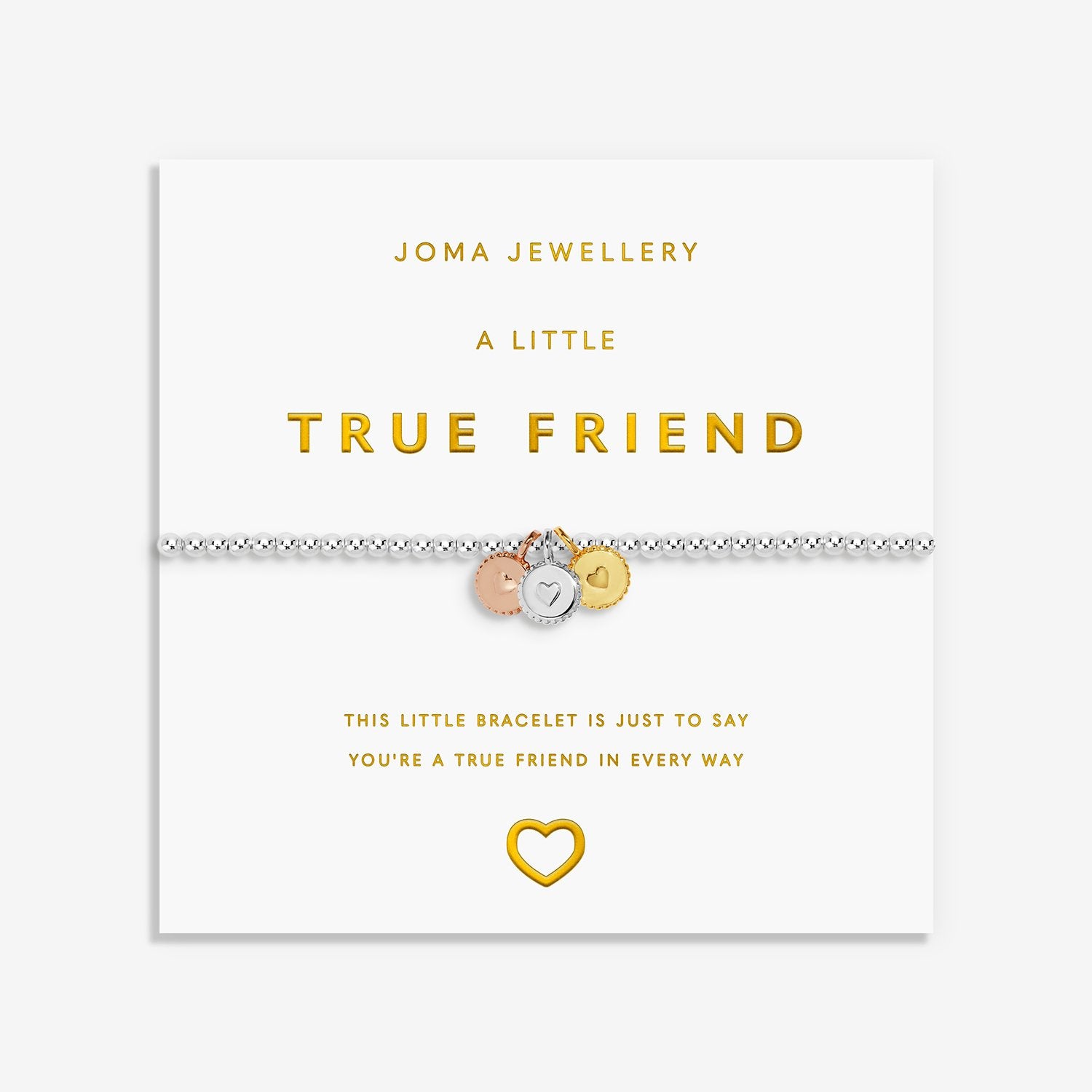 A silver friendship bracelet with three small charms (rose gold, silver, and gold) displayed on its white Joma Jewellery gift card, which features gold lettering and a gold heart outline.