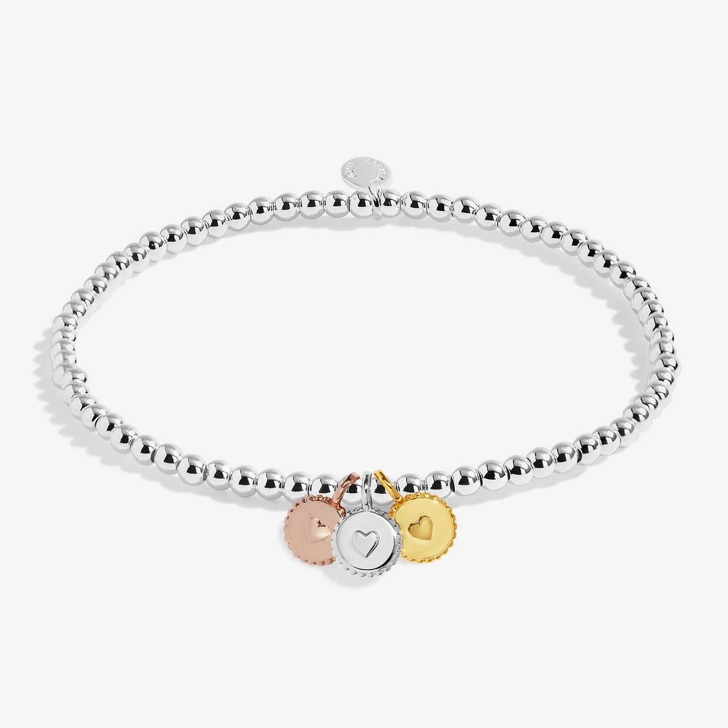 A silver beaded stretch bracelet with three small round charms in rose gold, silver, and yellow gold, displayed on a light gray background.