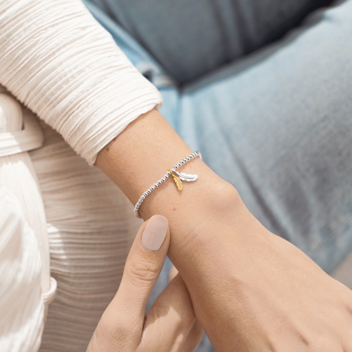Close-up of a wrist wearing two rings with a blurred background