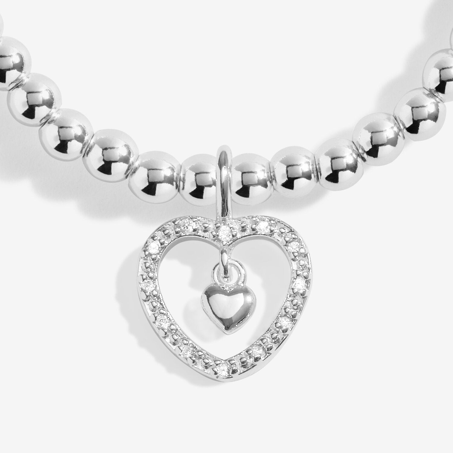 Silver beaded bracelet with a heart-shaped charm on a white background