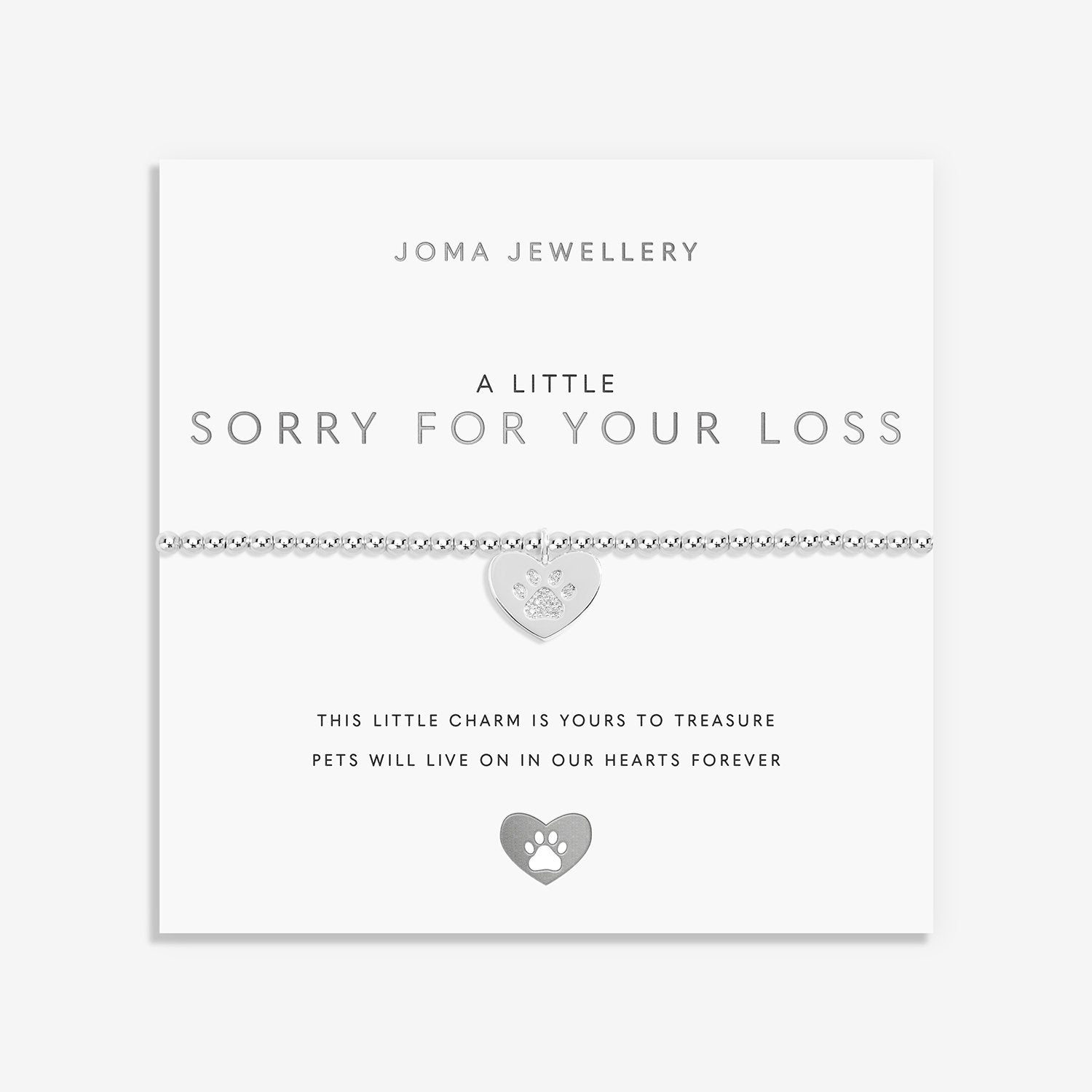 A silver pet memorial bracelet on a white Joma Jewellery card. The bracelet features a delicate link chain with a small heart-shaped charm engraved with a paw print and the word 'pet'.