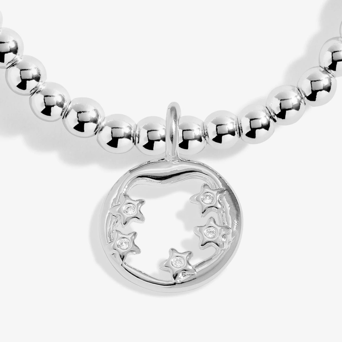 Silver beaded bracelet with a moon and star charm on a white background