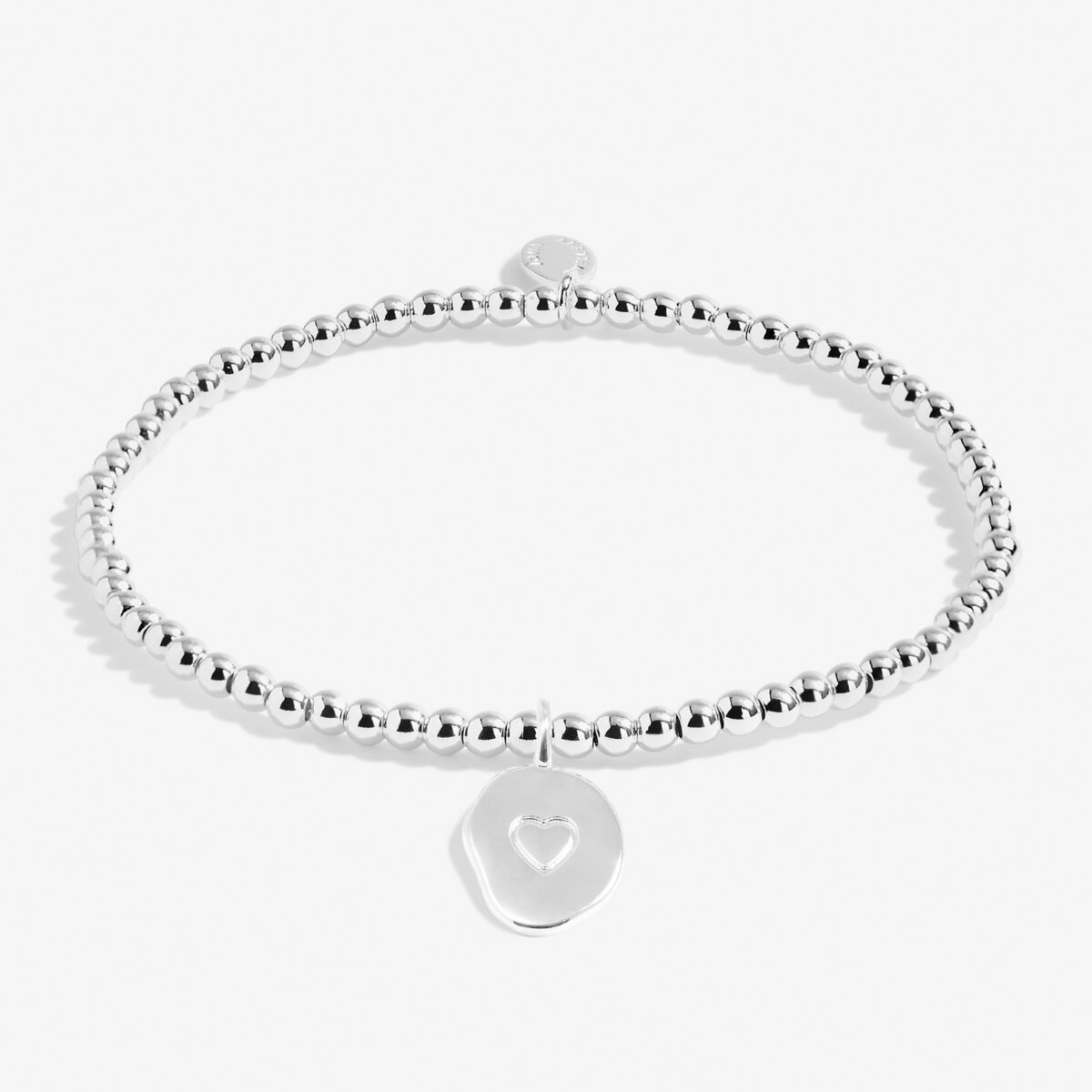 Silver bracelet with a heart-shaped charm on a white background