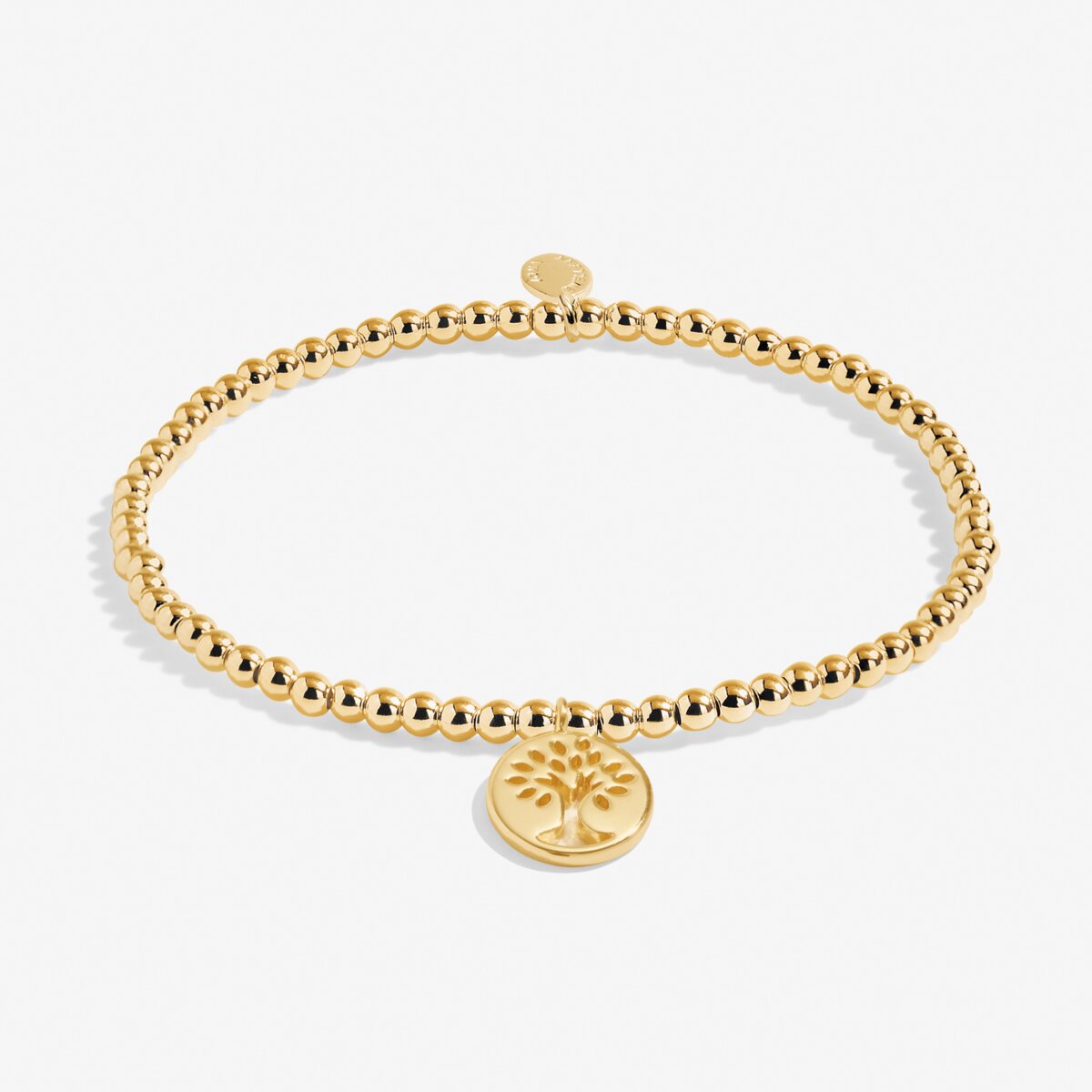 Gold beaded bracelet with a tree of life charm on a white background