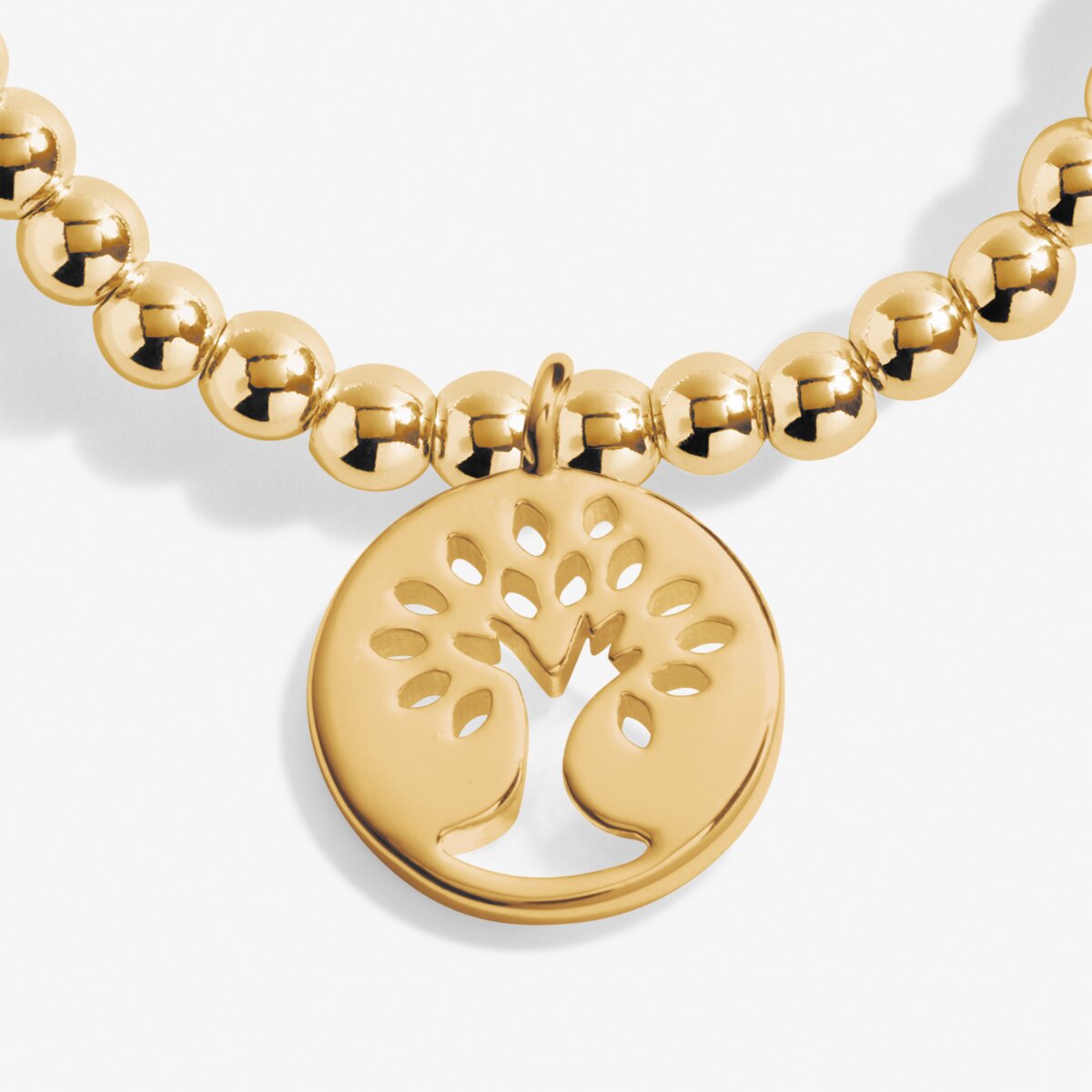 Gold beaded necklace with a tree of life pendant on a white background