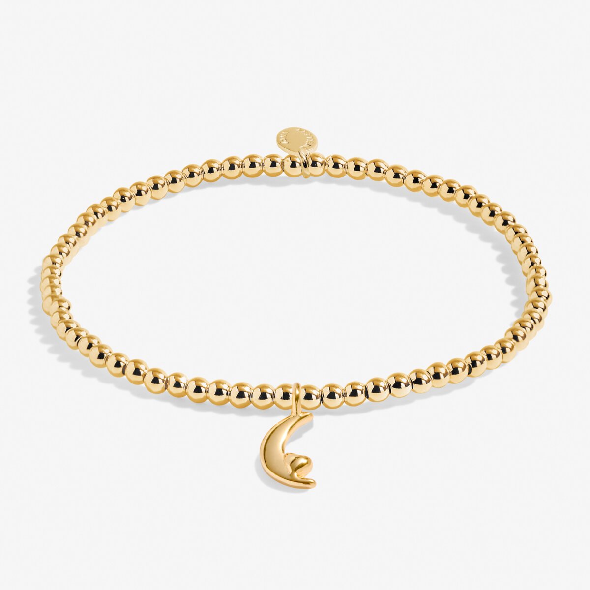 Gold bracelet with a moon charm on a white background
