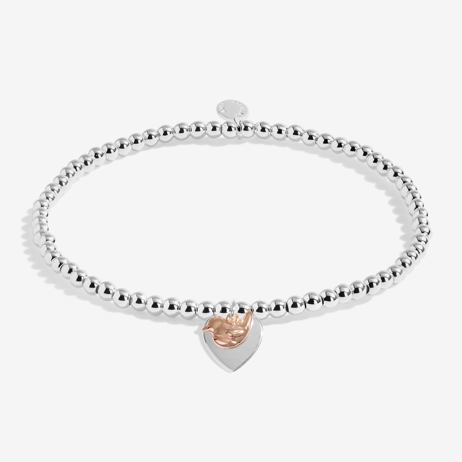 Silver bracelet with a heart-shaped rose gold charm on a white background