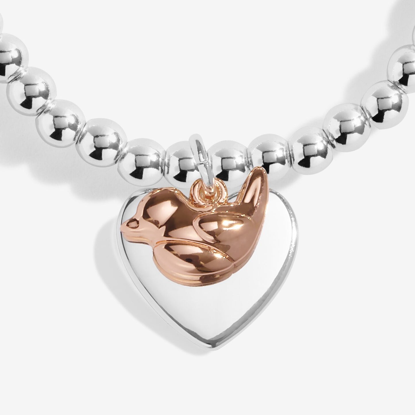 Bracelet with a heart-shaped charm featuring a rose gold bird design on a white background