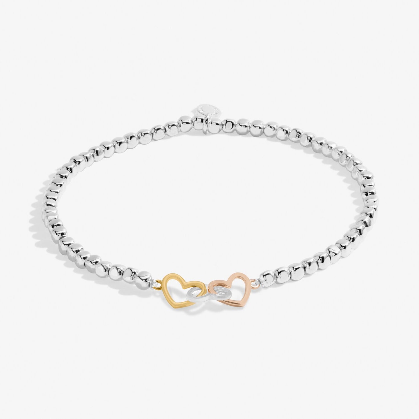 Silver bracelet with gold heart-shaped clasp on a white background