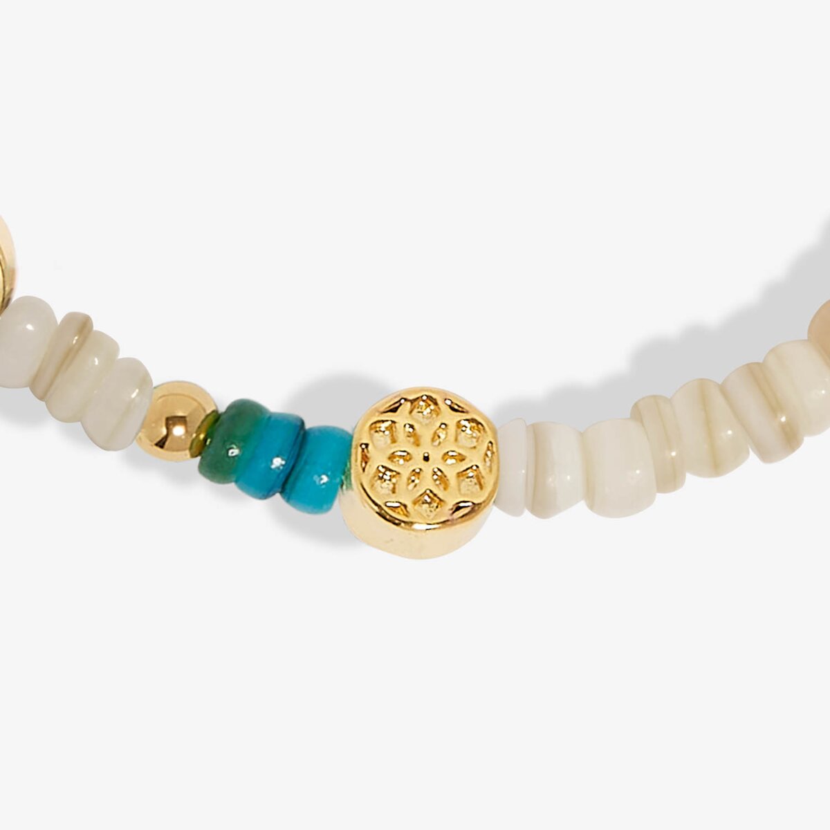 Beaded bracelet with gold, turquoise, and white beads on a white background