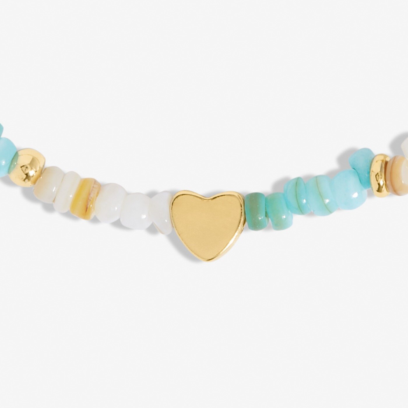 Bracelet with gold heart charm and turquoise beads on a white background