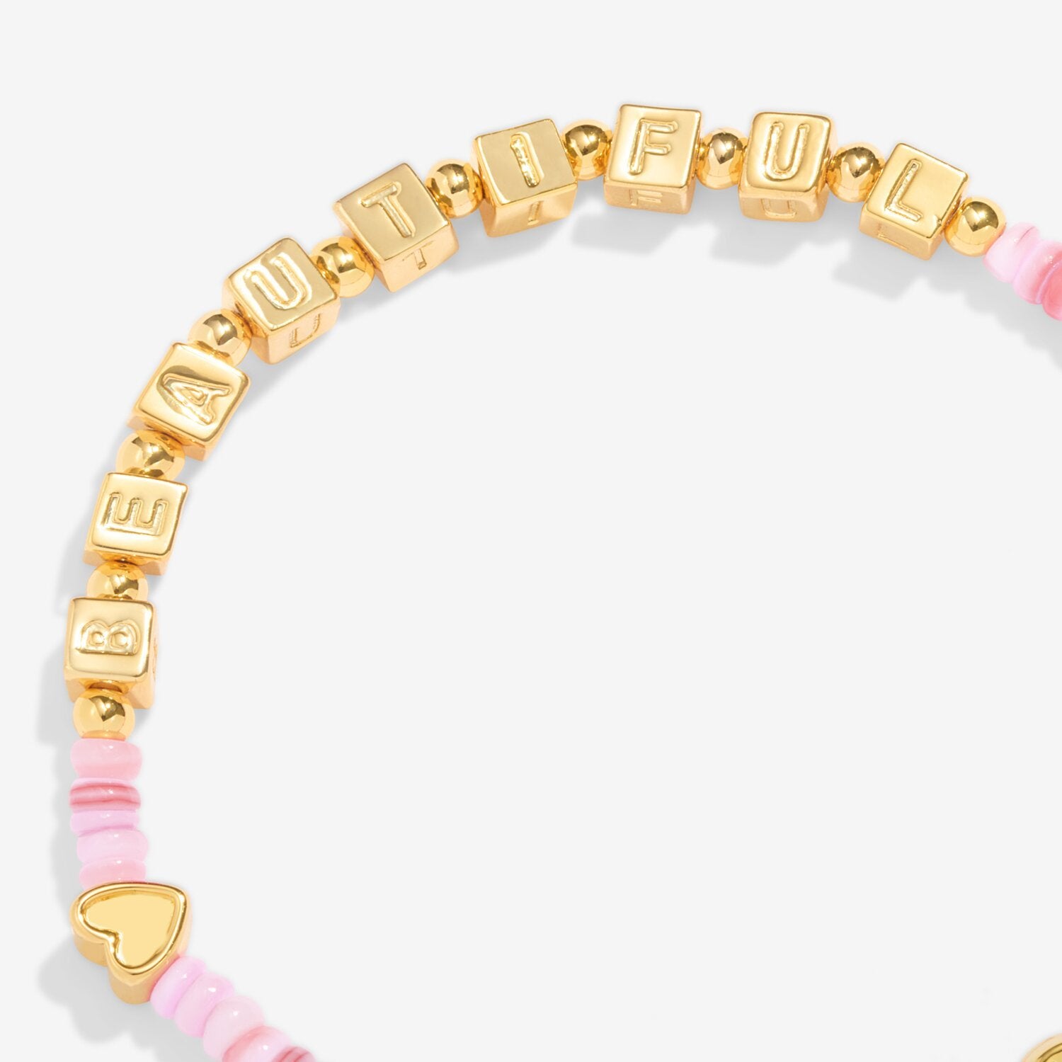 Gold and pink beaded bracelet with 'BEAUTIFUL' on a white background