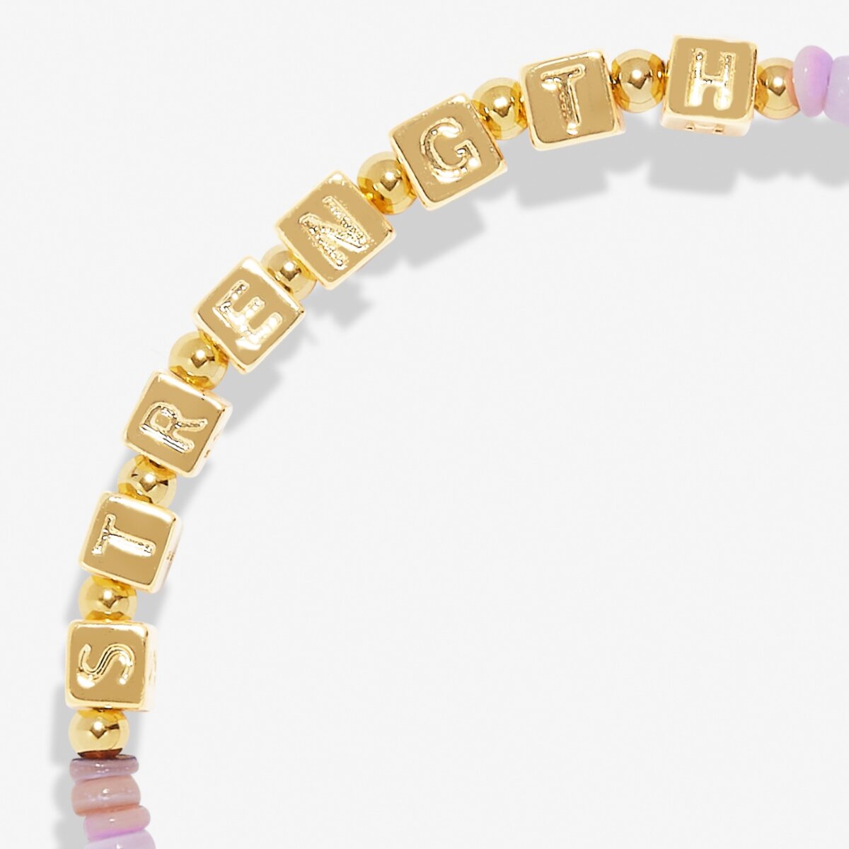 Gold bracelet with letter beads spelling out 'STRENGTH' on a white background