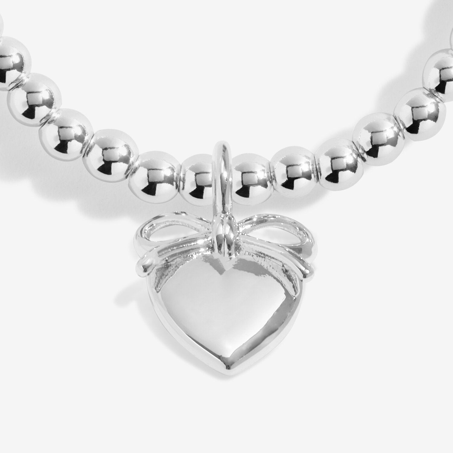 Silver beaded bracelet with a heart-shaped tag on a white background