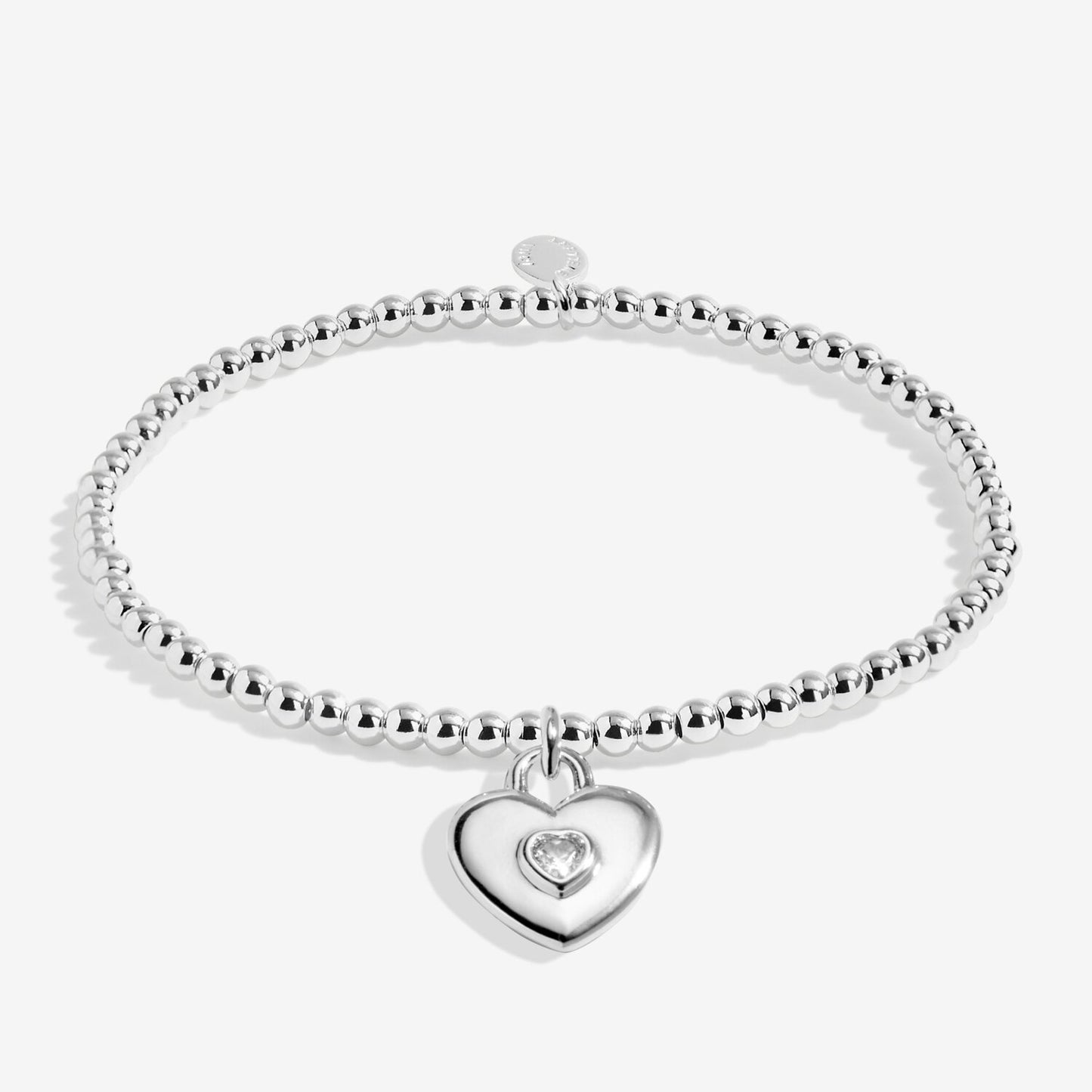 Silver bracelet with a heart-shaped charm on a white background