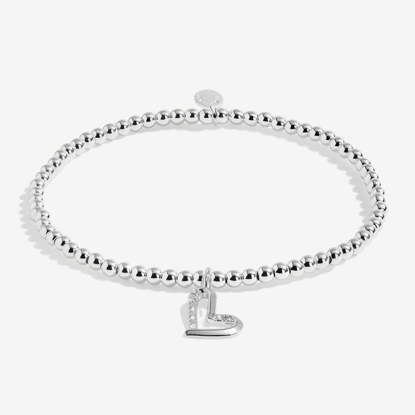 Silver bracelet with a heart charm on a white background