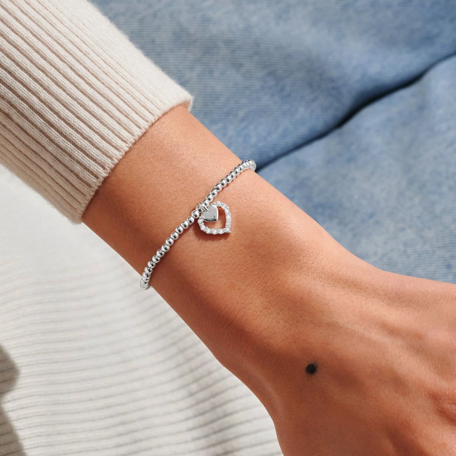 Silver bracelet on a wrist with a blurred background