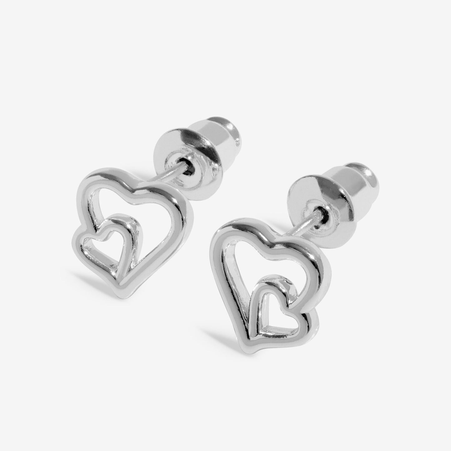 Silver heart-shaped earrings on a white background