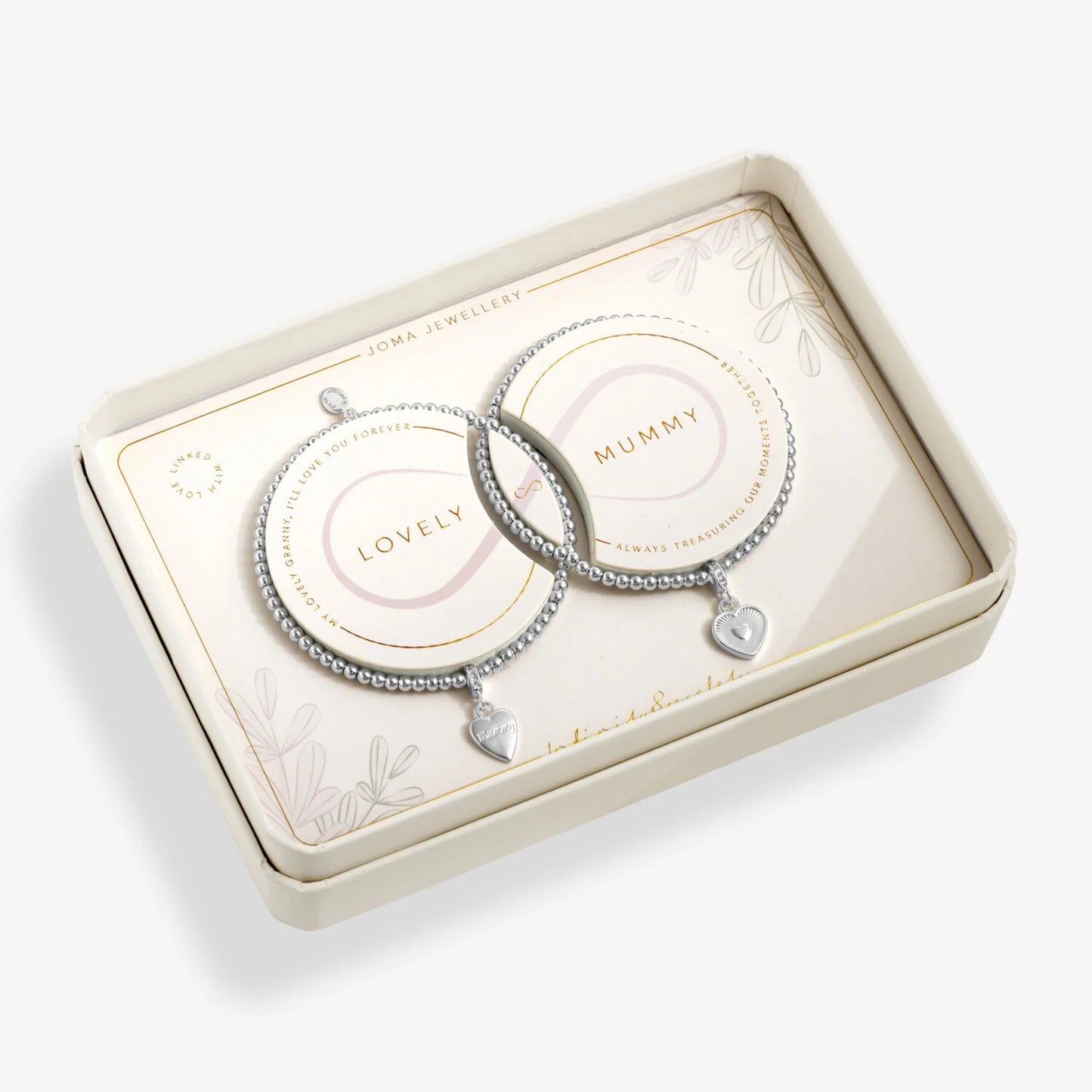 Two silver bracelets with heart charms in a decorative box.