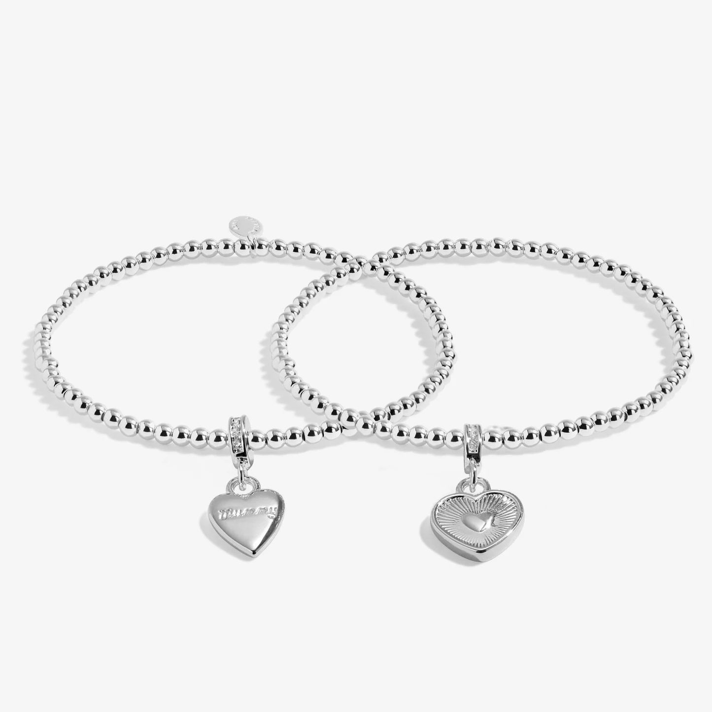 Two silver beaded bracelets with heart-shaped charms on a white background