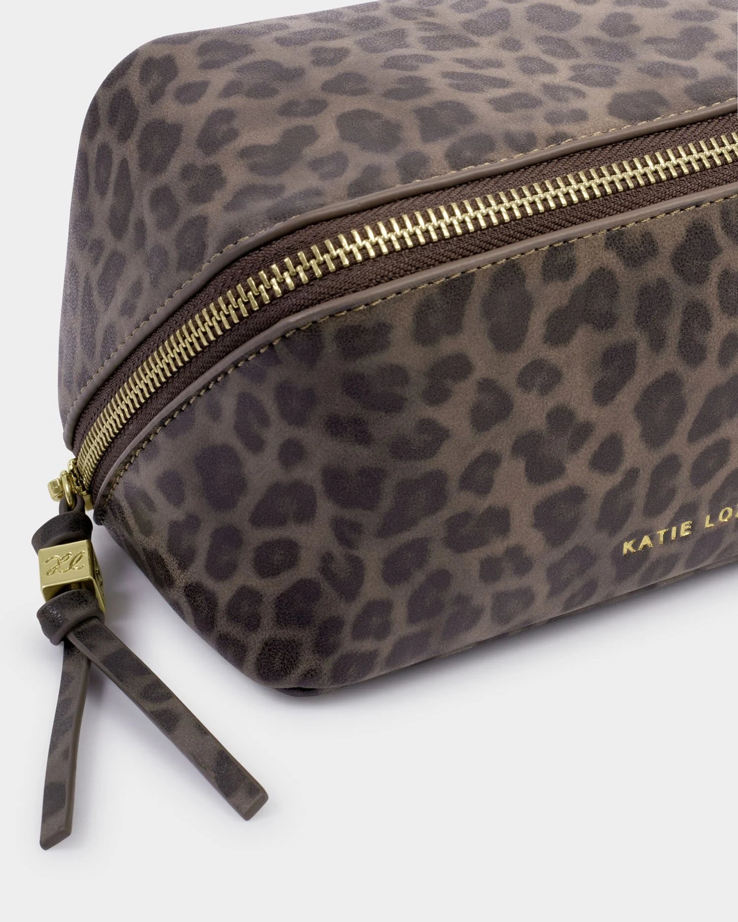 Leopard print makeup bag with gold zipper on a white background