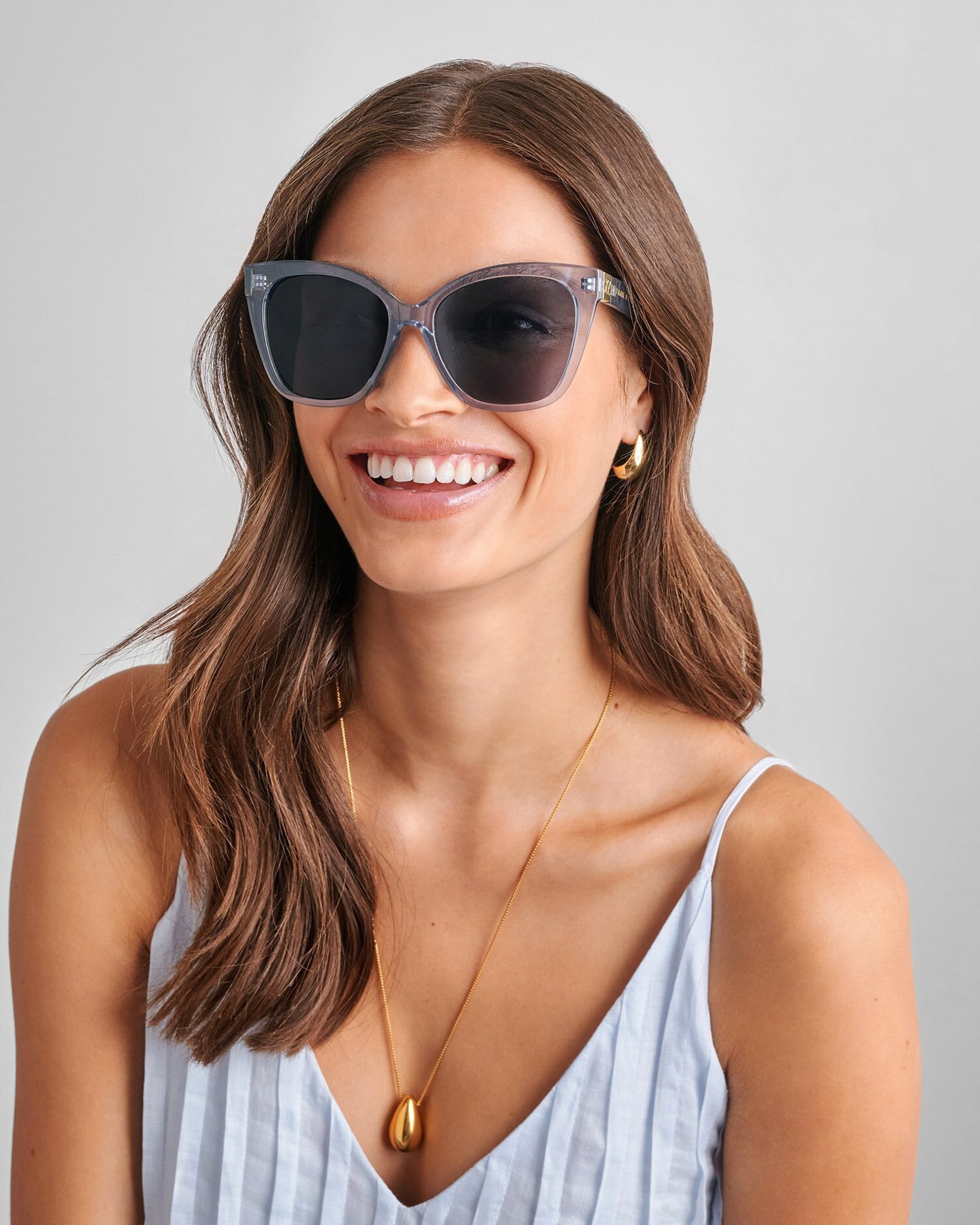 Model wearing blue sunglasses